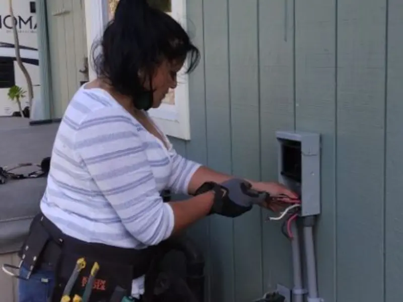 Licensed electrician wiring an exterior subpanel in Moline